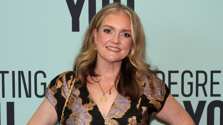 Colleen Hoover smiling wearing gold necklace