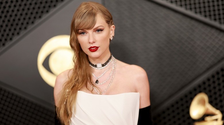 Taylor Swift in white gown on red carpet