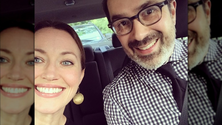 Rebecca Spence and Patrick Thomas Spence smile for a selfie inside their car.