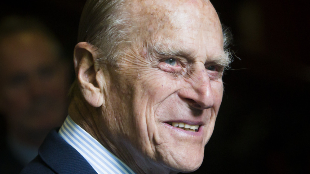 Prince Philip smiling in blue suit