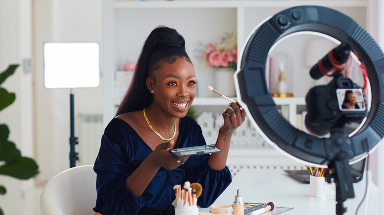 Woman applying makeup 