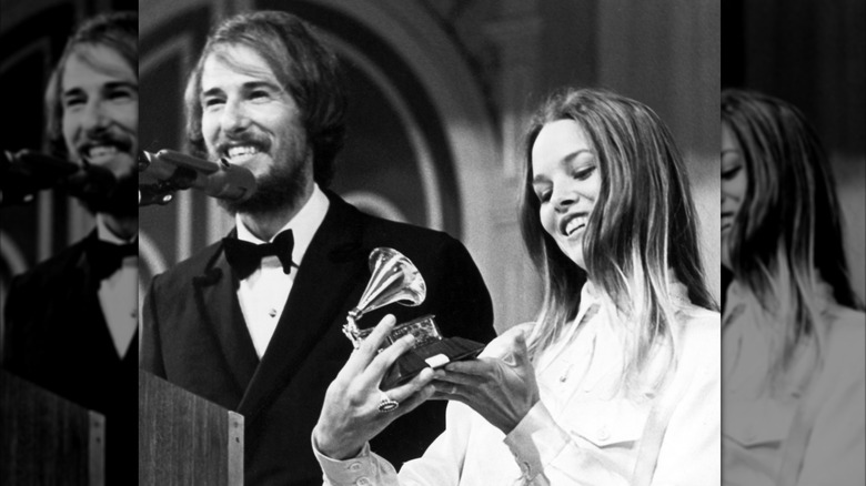 Michelle Phillips and John Phillips receiving a Grammy.