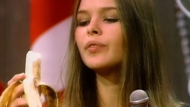 Michelle Phillips holding a banana on The Ed Sullivan Show in 1967.