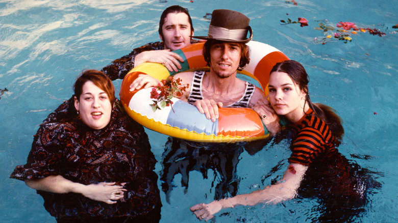 The Mamas & The Papas swimming in a pool.