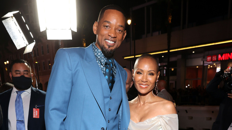 Jada Pinkett Smith and Will Smith smiling at the King Richard premiere in 2021.