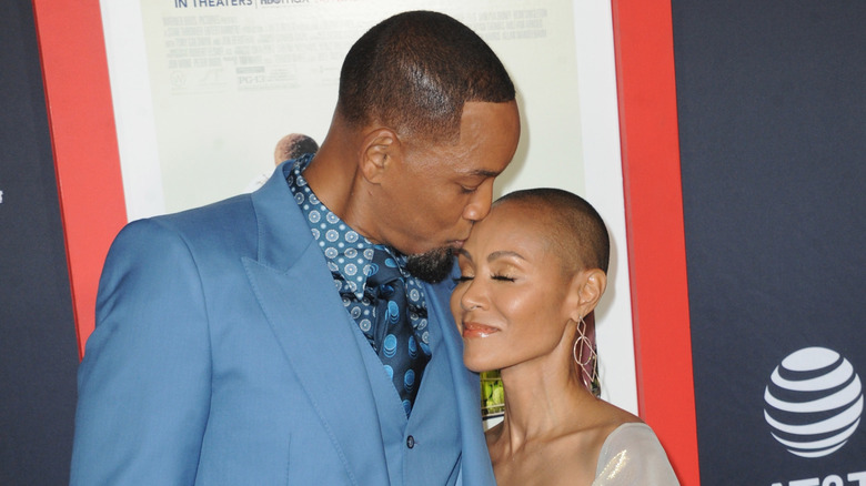 Will Smith kissing Jada Pinkett Smith's forehead at the premiere of King Richard in 2021.