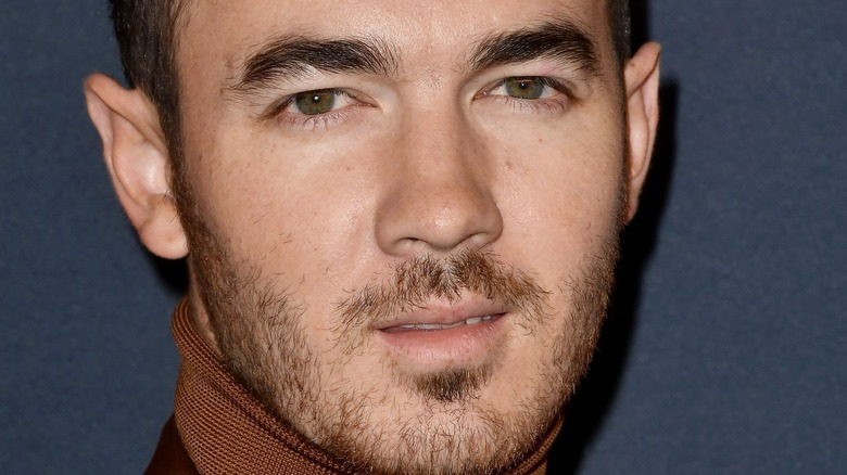 Kevin Jonas looking serious with facial hair