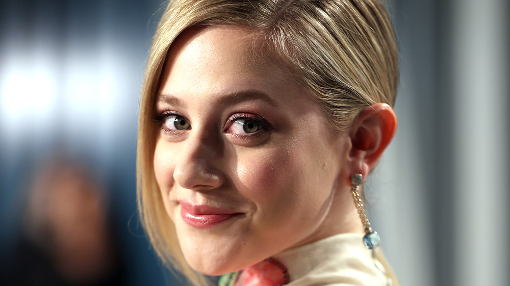 Lili Reinhart smiling over shoulder