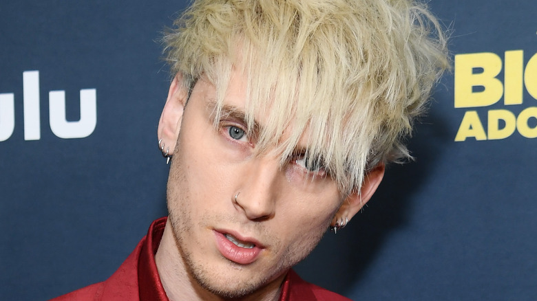 Machine Gun Kelly poses on the red carpet