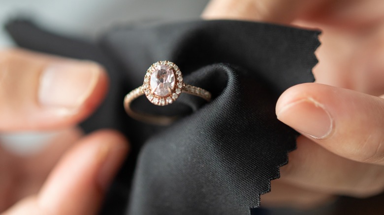 A person holding a diamond ring