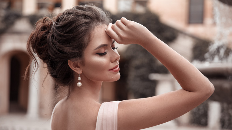 Woman wearing pearl earrings