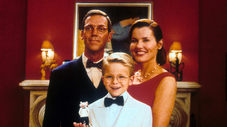 The cast of 'Stuart Little' smiling while standing in front of a painting