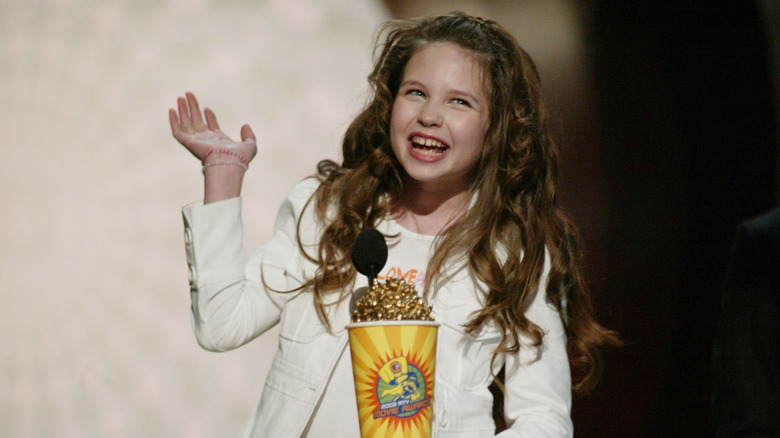 Daveigh Chase smiling as a kid with her 2003 MTV Movie Award for Best Villain