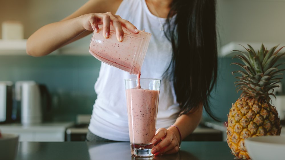 Woman pouring a smoothie