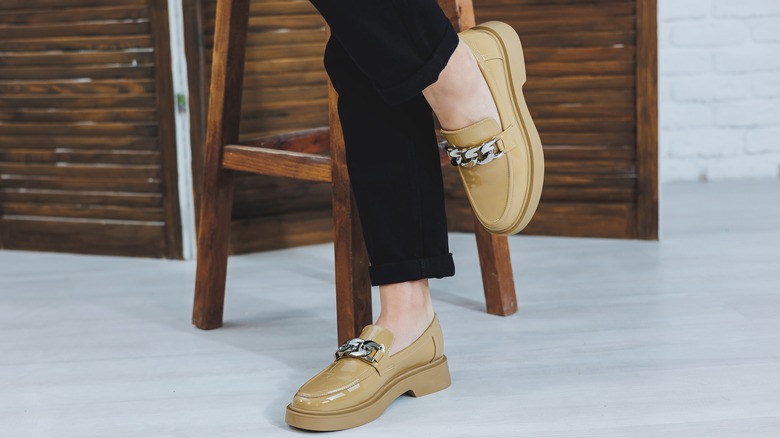 woman wearing cream loafers