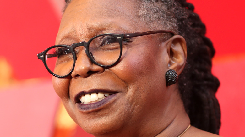 Whoopi Goldberg poses on the red carpet