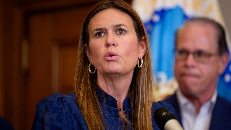 Sarah Huckabee Sanders looking confused in a dark blue top