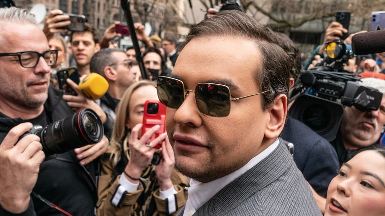 George Santos surrounded by reporters in New York City