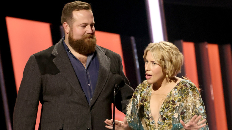 Ben Napier with his arm around Erin Napier while she speaks