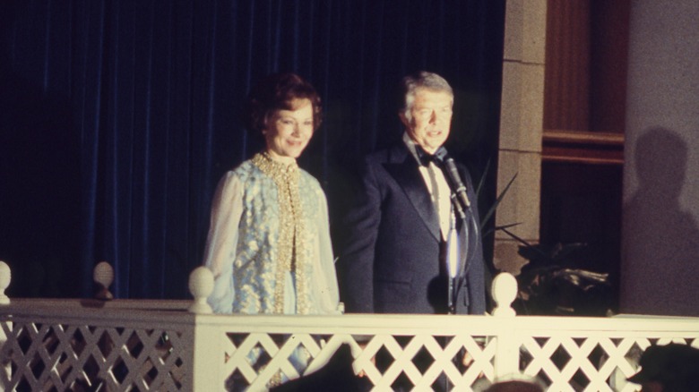 Rosalynn Carter and her husband Jimmy Carter appear at a balcony to make a speech during the 1977 presidential inauguration ball
