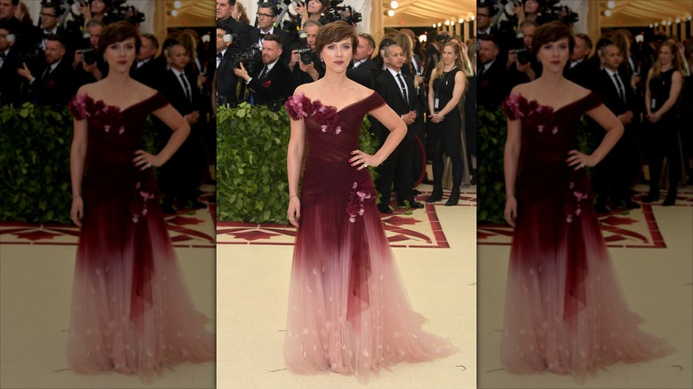 Scarlett Johanssonon the MET Gala carpet in a red and pink dress.