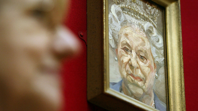 A portrait of Queen Elizabeth II in a small gold frame