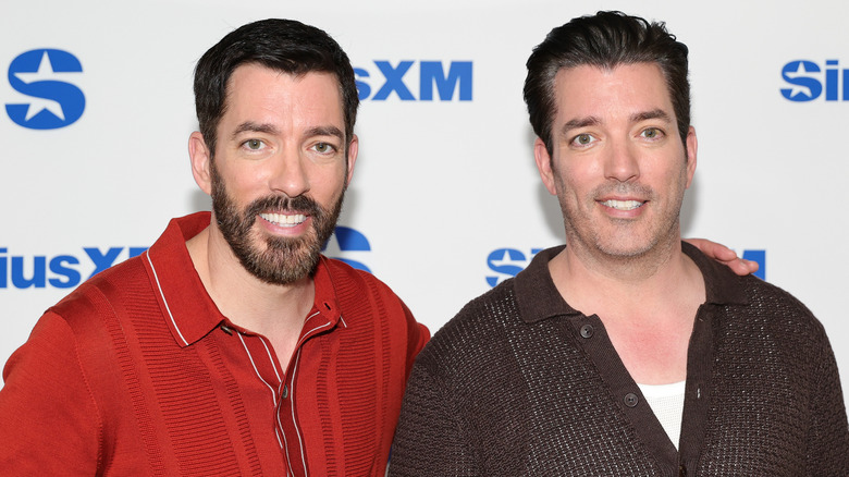 Jonathan Scott and Drew Scott posing at an event