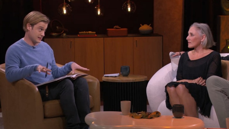 Tyler Henry and Ricki Lake sitting down talking on one of his Netflix shows