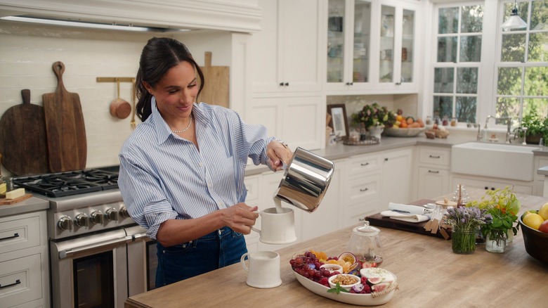 Meghan Markle pouring milk into a mug on With Love, Meghan