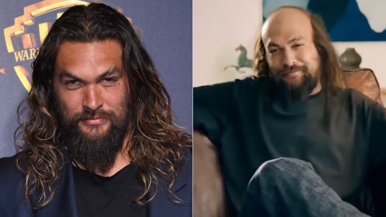 Jason Momoa with long hair and beard and with bald spot in black tee.