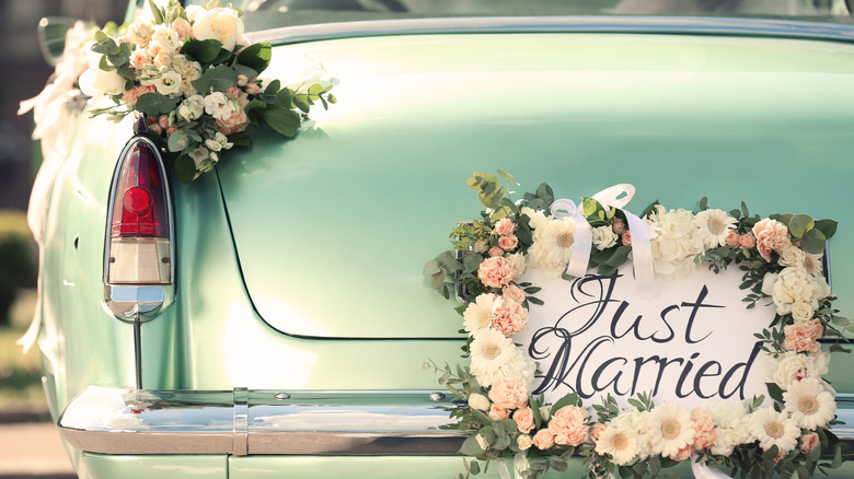 car with wedding sign on the back