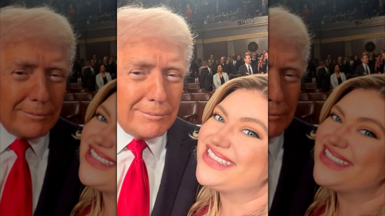 Congresswoman Kat Cammack poses for a selfie with Donald Trump at a political event