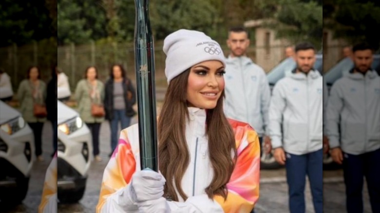 Kimberly Guilfoyle holding the Olympic torch while taking part in the relay