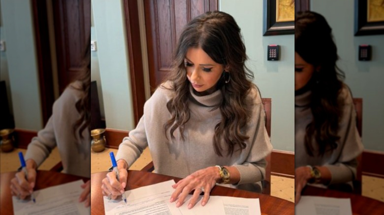 Kristi Noem poses while signing a contract for steel manufacturing