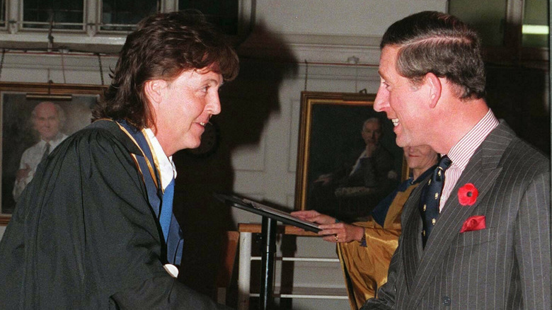 Paul McCartney and King Charles shaking hands