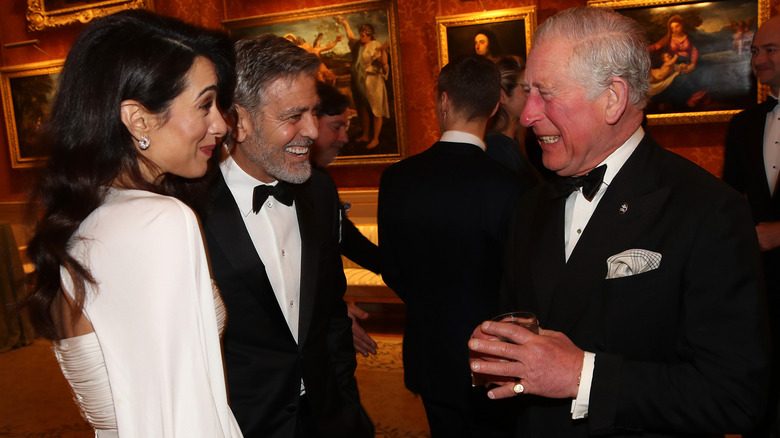 Amal Clooney, George Clooney laughing and talking with King Charles