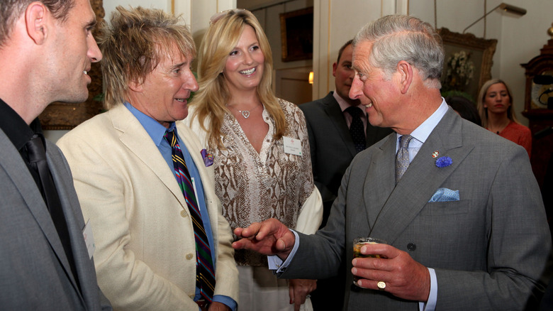 King Charles and Rod Stewart smiling and talking together