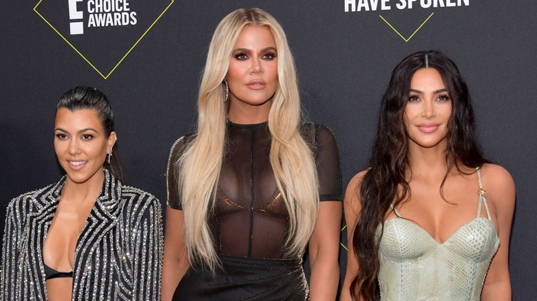 Kourtney, Khloé, and Kim Kardashian attend an awards show in 2019