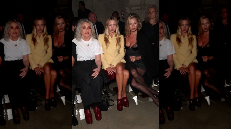 Kate and Lila Moss pose for photographers while sitting front row at the Gucci Cruise '25 show