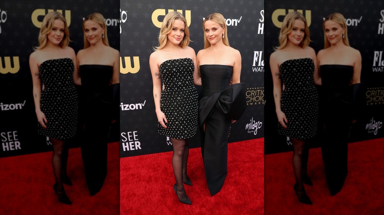 Ava Phillippe and Reese Witherspoon posing together at the critic's choice award red carpet in black strapless dresses