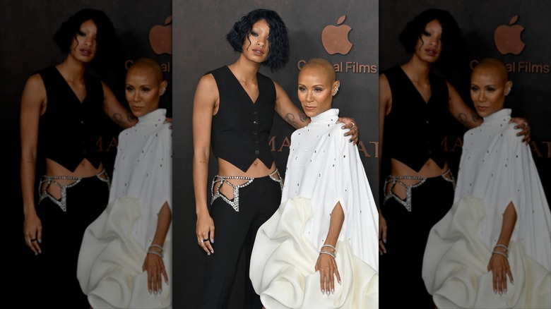 Willow Smith putting her arm around her mother, Jada, on the red carpet in bedazzled outfits