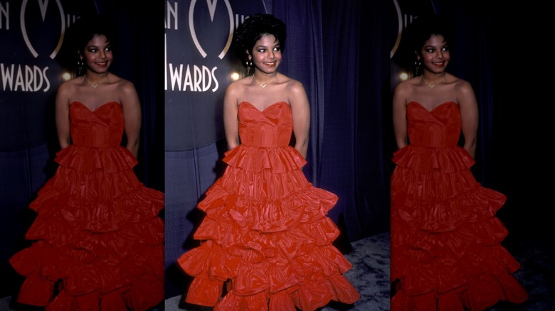 Janet Jackson in red strapless ruffled gown with short hair and gold hoops