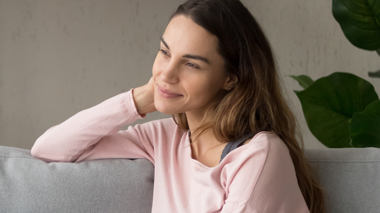 Woman smiling while contemplating