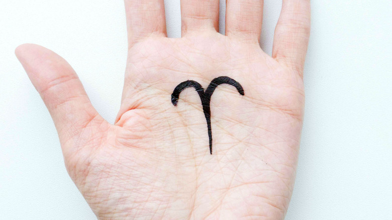 Aries sign on an open hand palm