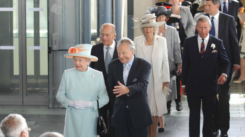 Queen Elizabeth II, Prince Philip, Camilla, Queen Consort, and King Charles III walking among crowd
