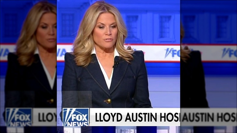 Martha Maccallum in a denim jacket in front of a news banner.