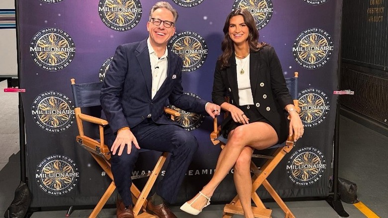 Jake Tapper and Kaitlan Collins pose together behind the scenes on "Who Wants To Be A Millionaire" (2025)