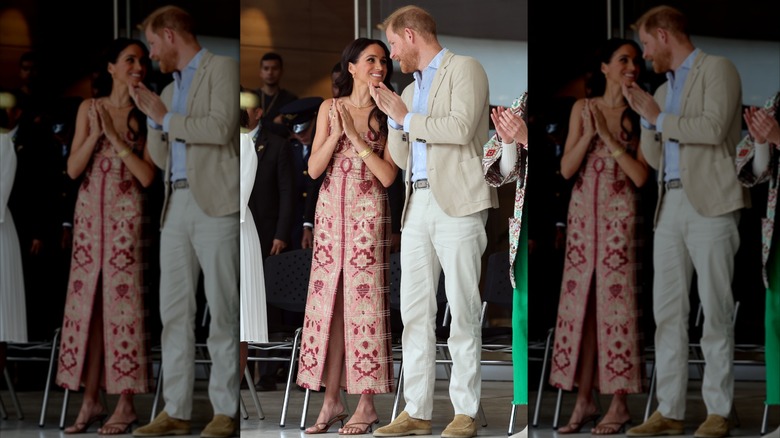 Meghan Markle and Prince Harry clapping and talking to each other