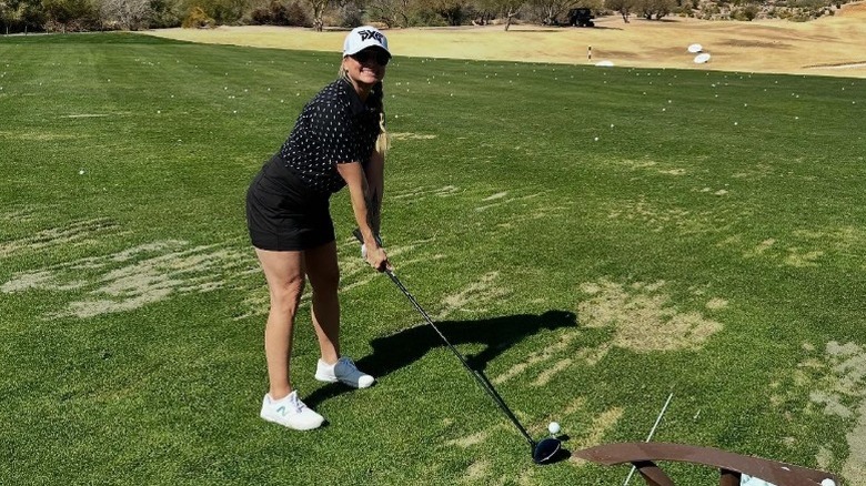 MIranda Lambert gets ready to swing a golf club on the greens (2025)