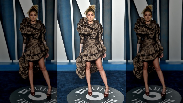 Paris Jackson in a brown structured dress on the blue carpet